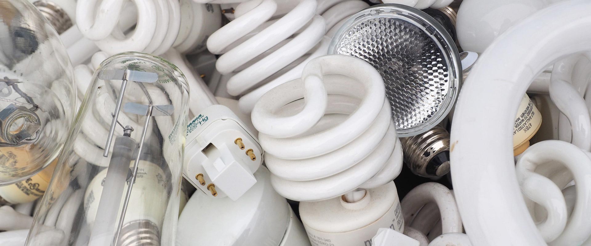 A picture of compact fluorescent blubs, pin lamps, hid bulbs, and halgoen bulbs. NLR recycles lamps and fluorescent bulbs.