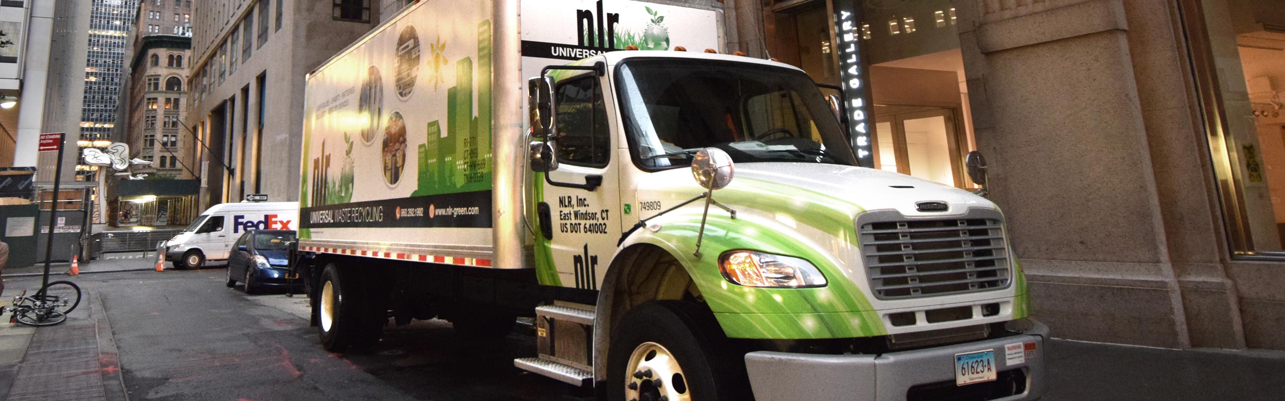 Picture of NLR's green and white box truck at a recycling pick-up in New York City. NLR has a complete fleet of trucks to service our recycling customers.